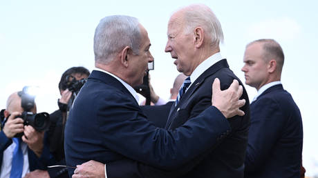 Israel Prime Minister Benjamin Netanyahu (L) greets US President Joe Biden in Tel Aviv on October 18, 2023
