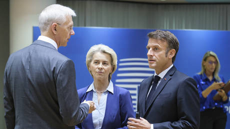  Latvian Prime Minister Krisjanis Karins is talking with the President of the European Commission Ursula von der Leyen and the French President Emmanuel Macron prior the start of the second day of an EU Summit, in the Europa, the EU Council headquarter.
