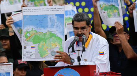 President of Venezuela Nicolas Maduro shows a national map during a march in favor of the Venezuelan position regarding the dispute over the territory of Essequibo with the Cooperative Republic of Guyana, in Caracas, Venezuela on December 8, 2023.