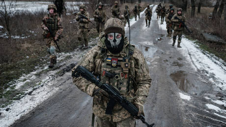 FILE PHOTO. Ukrainian servicemen walk toward their base near the frontline in the Donetsk region.