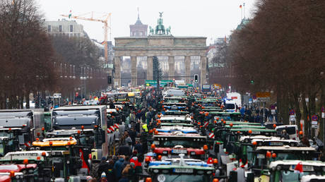 Farmers arrive on their tractors at the Brandenburg Gate to protest against planned cuts to state subsidies that bring down their fuel costs on December 18, 2023 in Berlin, Germany.
