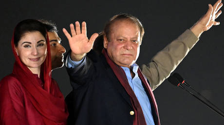 Pakistan's former Prime Minister Nawaz Sharif  stands beside his daughter Maryam Nawaz  during an event held to welcome him in Lahore on October 21, 2023.