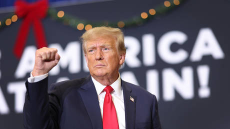 Republican presidential candidate and former U.S. President Donald Trump gestures as he wraps up a campaign event on December 19, 2023 in Waterloo, Iowa