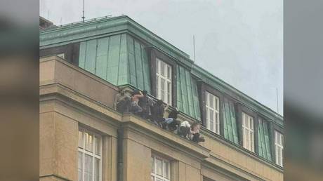 Students attempt to hide from an active shooter at Charles University in Prague, Czech Republic, December 21, 2023