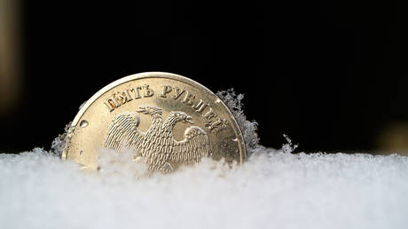 FILE PHOTO. Russian ruble frozen in the snow