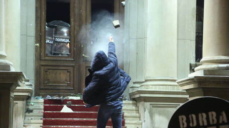 Protestors throw rocks staging a protest in front of Belgrade City Council building objecting to the result of general and local elections, in Belgrade, Serbia on December 24, 2023.