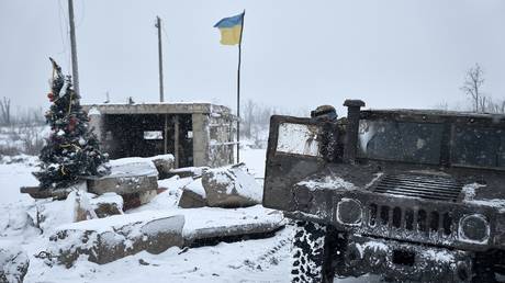 FILE PHOTO: Ukrainian soldiers pass a destroyed checkpoint.