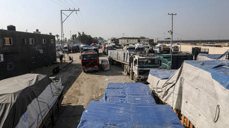 Humanitarian aid trucks from the UN and Red Crescent pass through the Rafah Border Crossing on the Egyptian border in Rafah, Gaza, December 18, 2023.