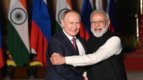 India's Prime Minister Narendra Modi (R) greets Russian President Vladimir Putin before a meeting at Hyderabad House in New Delhi on December 6, 2021.