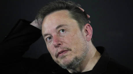 FILE - Elon Musk reacts during an in-conversation event with Britain's Prime Minister Rishi Sunak in London, England, November 2, 2023