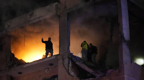 Civil defense workers search for survivors in the aftermath of a massive explosion that killed Hamas offical Saleh al-Arouri in Beirut, Lebanon, January 2, 2024