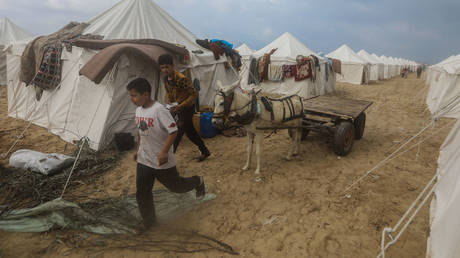 Palestinians whose homes were destroyed by Israeli bombing take refuge in a tent city built in Khan Younis