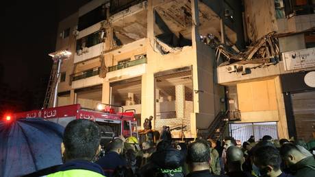 Lebanese emergency responders gather at the site of a strike targeting a Hamas office in the southern suburb of Beirut.