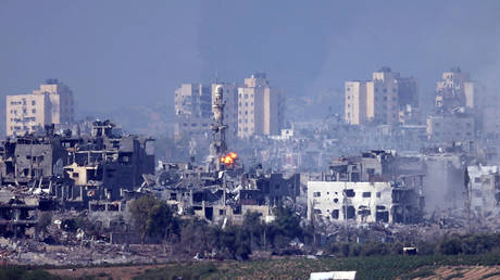 A missile strikes behind a minaret in Gaza on October 28, 2023 seen from Sderot, Israel