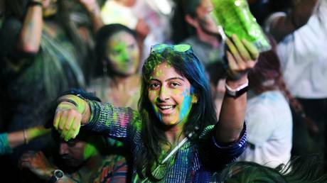 A young woman takes part in Holi Festival of Colours during the Day Of India ethnic festival at the Dream Island amusement park, in Moscow, Russia.