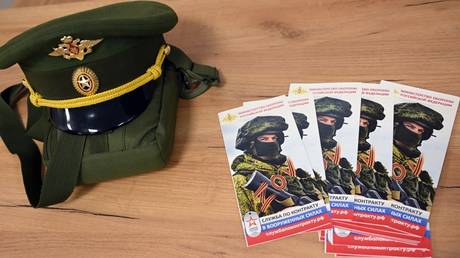 Information booklets and Russian military cap are pictured at a contract enlistment station.