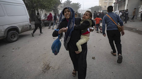 Palestinians evacuate from a site hit by an Israeli bombardment on Rafah, southern Gaza Strip, Wednesday, Dec. 20, 2023