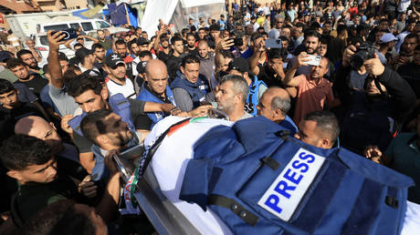 Journalists, relatives and friends pray over the body of Palestine TV journalist Mohamed Abu Hatab, killed in an Israeli bombardment of southern Gaza Strip on November 3, 2023