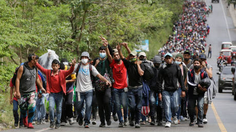 A US-bound migrant caravan enters Guatemala from Honduras after breaking a police barricade in January 2021.