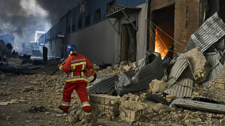 Ukrainian emergency workers respond to a warehouse fire in Kiev following a Russian airstrike on December 29.