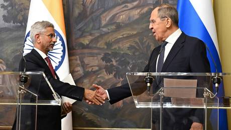 Russian Foreign Minister Sergey Lavrov and Indian Foreign Minister Subrahmanyam Jaishankar, left, shake hands during a joint news conference following their meeting, in Moscow, Russia.
