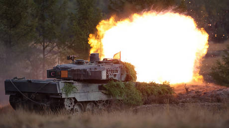 A German Leopard 2 main battle tank shoots during a training exercise at the military ground in Ostenholz, northern Germany, on October 17, 2022.