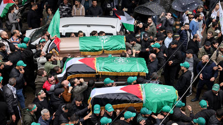 Mourners carry the coffins of Hamas officials, killed on January 2, 2024 in a strike in Beirut's southern suburbs, during their funeral procession in Lebanon's capital on January 4, 2024.