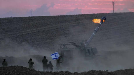 FILE PHOTO: An Israeli mobile artillery unit fires a shell from a position near the Israel-Gaza border.