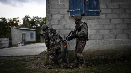 FILE PHOTO. Ukrainian soldiers stand near a building during a training exercise with French soldiers at a French military camp in France.
