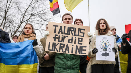A protester holds a banner reading "TAURUS for Ukraine" as activists from the German-Ukrainian group Vitsche protest outside the Chancellery to demand increased military support from Germany to Ukraine on January 6, 2024 in Berlin, Germany