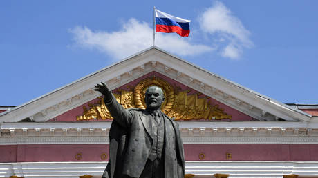 FILE PHOTO: A Russian national flag flies in the wind above a monument to the Soviet State founder Vladimir Lenin in the Russian city of Kursk on May 28, 2023.