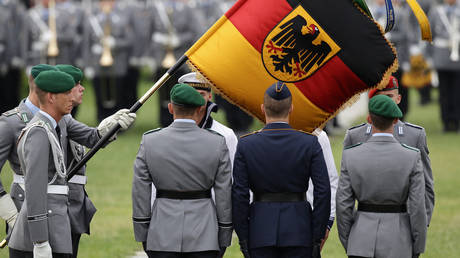 Soldiers of the German Bundeswehr stand at attention at a swearing-in ceremony for new recruits in front of the Reichstag on July 20, 2011 in Berlin, Germany