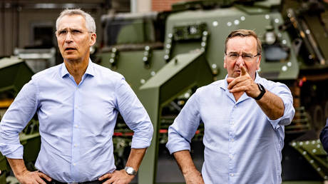 FILE PHPTO: German Defence Minister Boris Pistorius (R) and NATO Secretary General Jens Stoltenberg stand in front of a mine clearance tank.