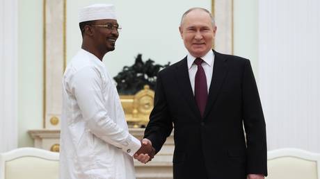 Russian President Vladimir Putin and interim President of Chad Mahamat Idriss Deby shake hands as they attend a meeting at the Kremlin in Moscow, Russia.