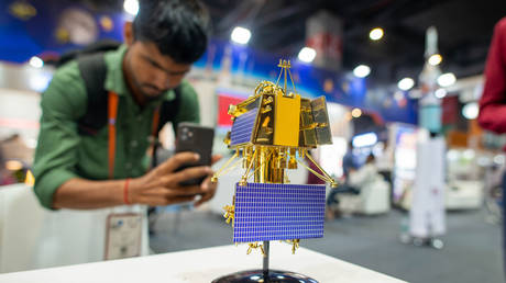 A man seen photographing a scale model of the Chandrayaan 3 Vikram Lander at the Indian Space Research Organisation