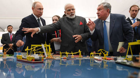 Russian President Vladimir Putin and Indian Prime Minister Narendra Modi  listen to Rosneft CEO Igor Sechin as they visit the Zvezda shipyard in the Russian Far East. Zvezda is building large oil tankers to ferry Russian crude across the world, including India.