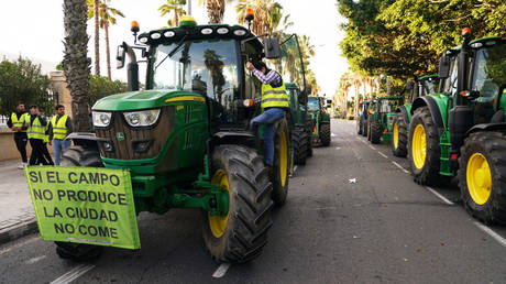 Farmers block roads in Malaga, Spain, on February 6, 2024. The poster reads "If the field doesn't produce, the city doesn't eat".