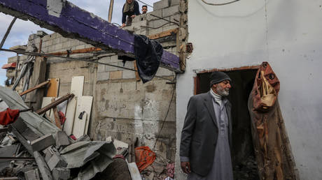 FILE PHOTO: Palestinians inspect the damage after an Israeli strike in Rafah, Gaza, January 14, 2024.