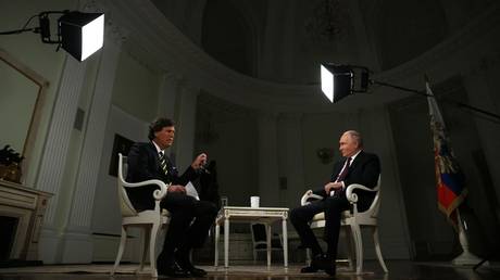 Russian President Vladimir Putin listens to a question during an interview with US journalist Tucker Carlson at the Kremlin in Moscow, Russia.