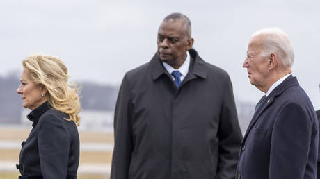First lady Jill Biden and President Joe Biden walk past Secretary of Defense Lloyd Austin during a casualty return for US troops killed in Jordan, at Dover Air Force Base, Delaware, February 2, 2024.