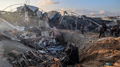 Palestinians inspect a building destroyed by Israeli bombardments in Rafah in the Gaza Strip on February 19, 2024.