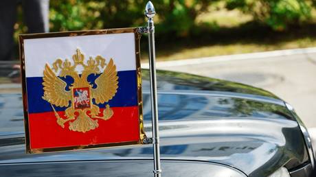 FILE PHOTO: A car bearing a Russian flag during President Vladimir Putin's arrival at the Vostochny Cosmodrome in Russia’s Far East, September 13, 2023.