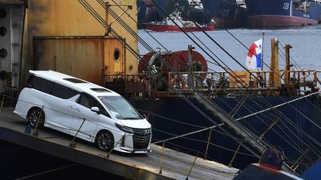 FILE PHOTO: A used car imported from Japan is unloaded from a ship at the commercial port of Vladivostok, Russia.