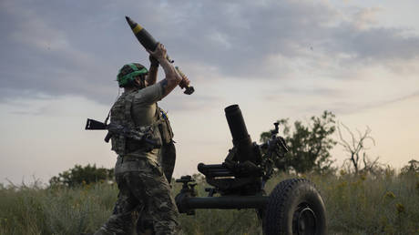 A Ukrainian serviceman fires a 122mm mortar towards Russian positions near Artyomovsk, Russia, July 2, 2023