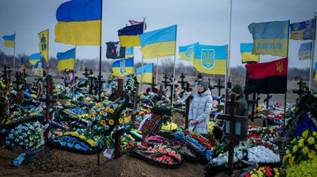 Relatives of a deceased Ukrainian soldier visit his grave on Sunday in Odessa.