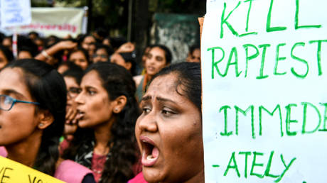 Students of Maharani's Women's College hold placards and shout slogans to protest against the alleged rape and murder of a 27-year-old veterinary doctor in Hyderabad, during a demonstration in Bangalore on December 3, 2019.