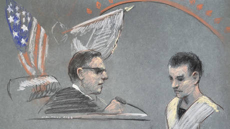 FILE PHOTO. Massachusetts Air National Guardsman Jack Teixeira, right, appears in US District Court in Boston, on April 14, 2023.