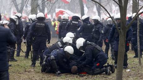 Police officers detain a man during a farmers’ protest in Warsaw, Poland on March 6, 2024.