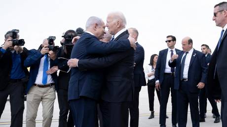 Benjamin Netanyahu (L) hugs Joe Biden upon the latter's arrival at Ben Gurion airport in Tel Aviv, Israel, October 18, 2023