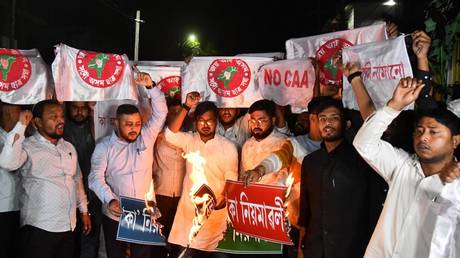 Activists of All Assam Students’ Union (AASU) set alight copies of Indian government's Citizenship Amendment Act (CAA) during a protest in Guwahati on March 11, 2024.